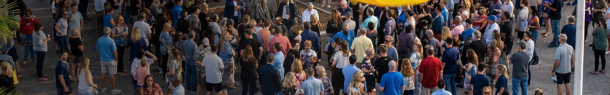 A crowd gathers outside the Goldland town hall to protest at intimidation from Redland.